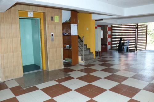 a lobby with a staircase in a building at Maass Homestay in Puducherry