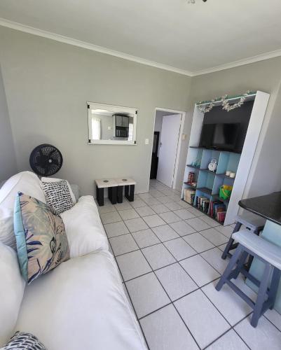 a living room with a white couch and a table at APPLES APARTMENT 6B in Cape Town