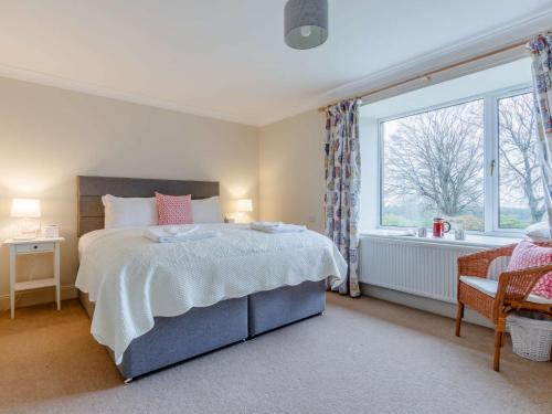 a bedroom with a bed and a large window at 2 Bed in Blair Drummond 81513 in Doune