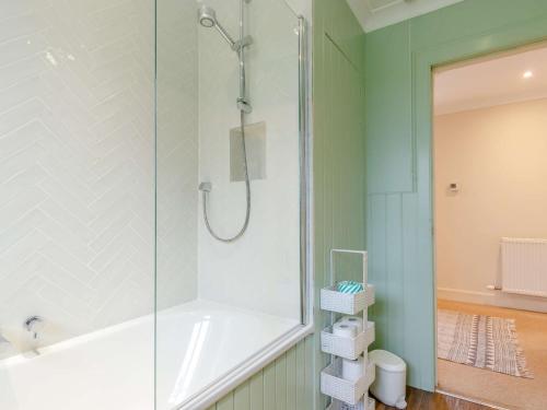 a bathroom with a shower and a tub at 2 Bed in Blair Drummond 81513 in Doune