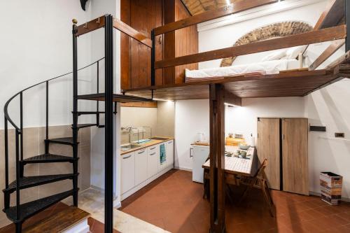 a room with two bunk beds and a kitchen at FCR Rome Apartments Piazza Navona - Teatro Pace in Rome