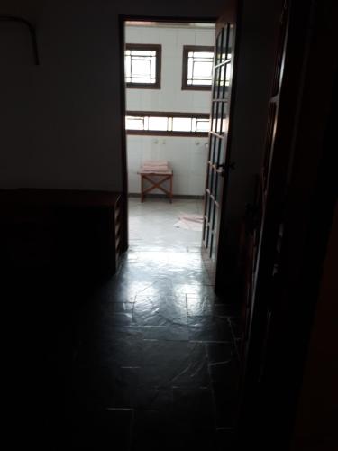 a dark hallway with a window and a table at Terapias integrativas do Sandrin in Jundiaí