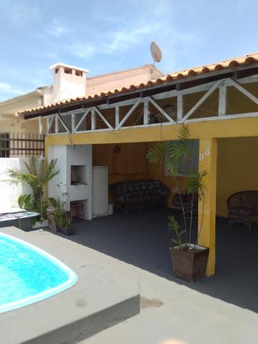 a house with a swimming pool in front of it at Brisa do Mar Guaratuba in Guaratuba