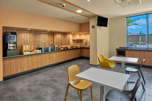 a restaurant with two tables and chairs and a counter at City Express Plus by Marriott Cabo San Lucas in Cabo San Lucas