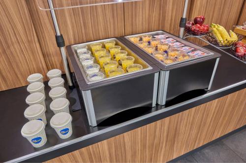a refrigerator with two trays of food and some drinks at City Express Plus by Marriott Cabo San Lucas in Cabo San Lucas