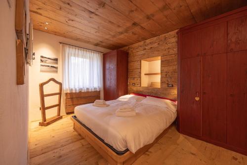 a bedroom with a bed in a wooden room at Casa Alvera Dream in Cortina dʼAmpezzo