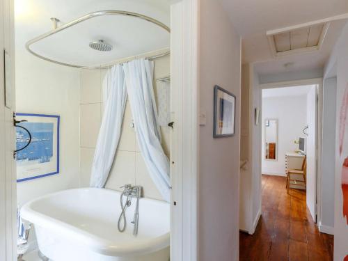 uma banheira branca na casa de banho com uma janela em 2 bed in Brixham 82723 em Brixham