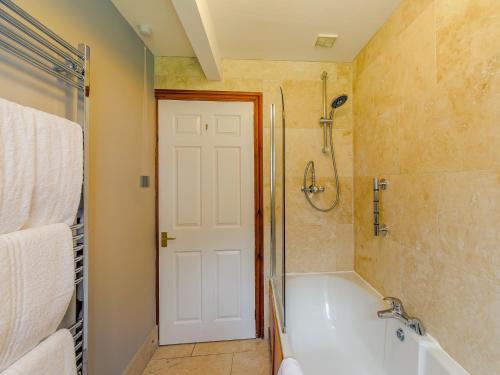 a bathroom with a shower and a bath tub at 1 bed property in Easingwold 84002 in Crayke