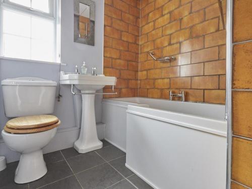 a bathroom with a toilet and a sink and a bath tub at 3 Bed in Grange in Borrowdale SZ262 in Grange