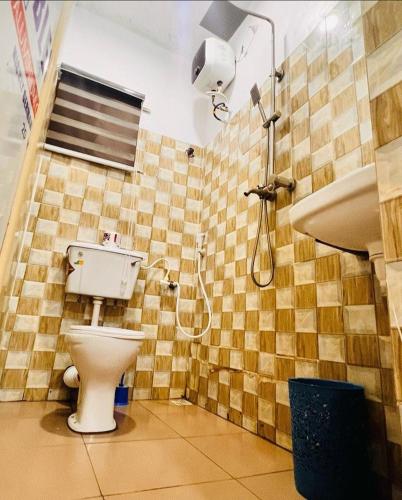 a bathroom with a toilet and a shower at Petra Homes B in Lagos