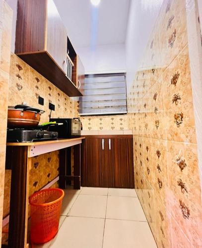 a kitchen with wooden cabinets and a counter top at Petra Homes B in Lagos