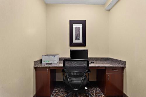 an office with a desk with a computer and a chair at Sleep Inn & Suites near Joint Base Andrews-Washington Area in Morningside