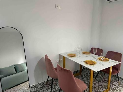 a dining room with a table and chairs and a mirror at Family Apartment With Private Yard Next to Agios Dimitrios Church in Thessaloniki