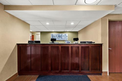 an office with a large wooden reception desk at Sleep Inn & Suites near Joint Base Andrews-Washington Area in Morningside