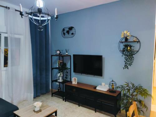 a living room with a tv on a blue wall at Wallada Marbella in Marbella