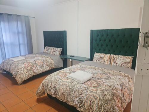 Letto o letti in una camera di HASATE GUEST HOUSE 13 LOUWVILLE STREET BELLIVILLE Cape Town south Africa