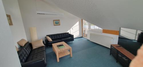 a living room with a couch and a table at Alpenblick in Leutkirch im Allgäu