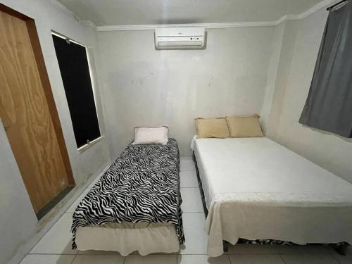 Tempat tidur dalam kamar di Pousada da Nicole