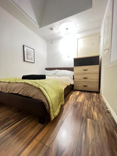 a bedroom with a bed and a dresser in it at Double Room Near City Centre With Extra Lounge Area in Preston