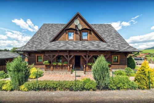 a log home with a gambrel roof at Drevenica pod Sitieňom 1 in Lazisko