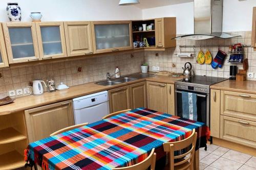 a kitchen with a table with a colorful table cloth on it at Avar residents Pärnu kesklinnas in Pärnu