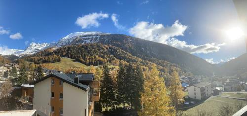 a snow covered mountain with a town and a city at Apartmenthaus Majesta in Leukerbad