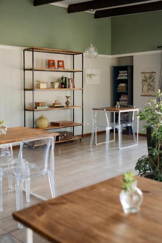 a room with tables and chairs and a book shelf at Elianthe Guesthouse in Swellendam