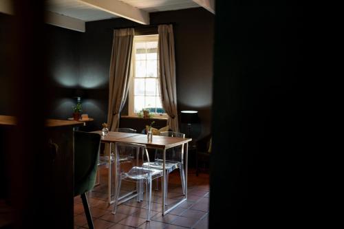 a dining room with a table and chairs and a window at Elianthe Guesthouse in Swellendam