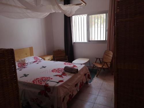 a bedroom with a bed and a window at Auberge Keur Diame in Dakar