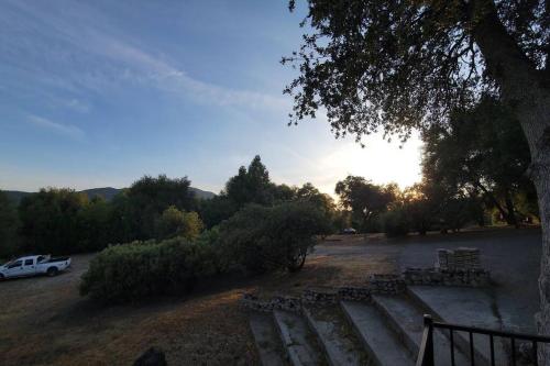 a group of benches in a parking lot with a car at Peaceful Yosemite Retreat-King Suite-Pet Friendly in Oakhurst
