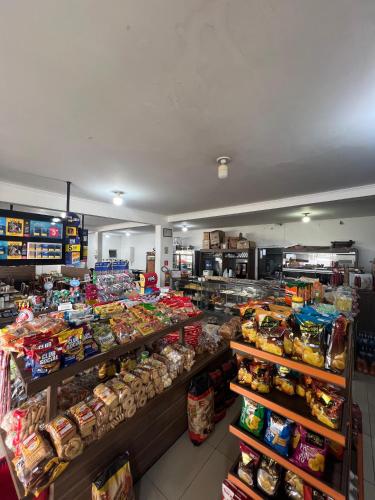 a store filled with lots of different types of food at Pousada Route 58 in Gravataí