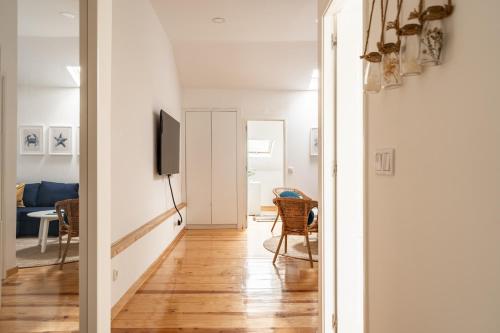 a hallway leading to a living room with a television at Akicity Anjos Splendid in Lisbon