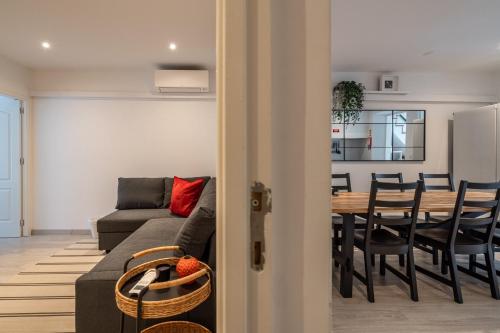 a living room with a couch and a table with chairs at Akicity Anjos Splendid in Lisbon