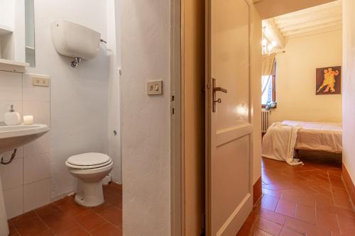 bagno con servizi igienici, lavandino e letto di Fuga romantica a Montepulciano a Montepulciano