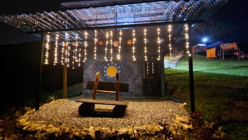a wooden bench sitting under a structure with lights at Carpe Diem in Guatavita