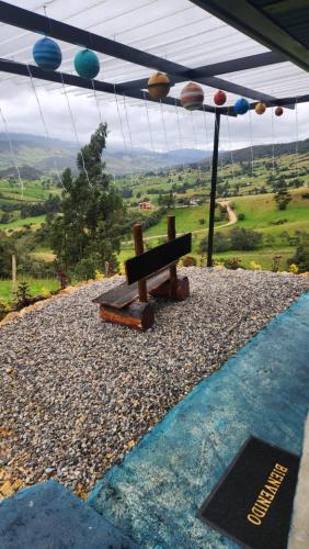 a wooden bench sitting on top of a hill at Carpe Diem in Guatavita