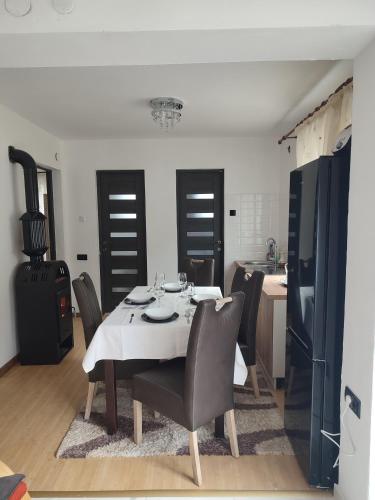 una sala da pranzo con tavolo e sedie e una cucina di Cabana Good Vibes a Cluj-Napoca