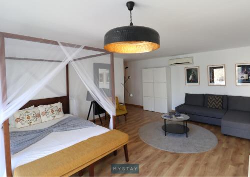 A bed or beds in a room at MyStay - Casa de Baco