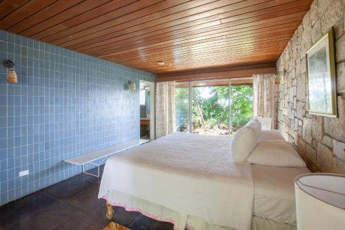 a bedroom with a bed in a room with a window at Frenchman's Cove Resort in Port Antonio
