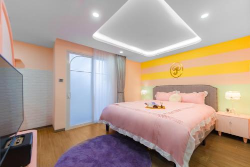 a bedroom with a large bed and a tv at Pavillon Garden Hotel & Spa Nha Trang in Nha Trang