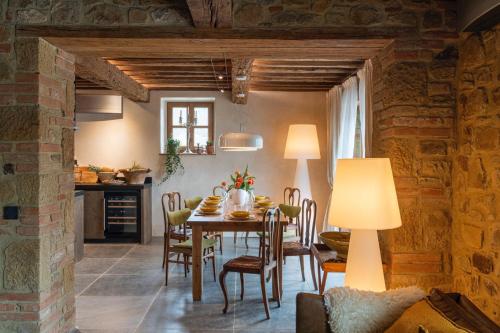 a kitchen and dining room with a table and chairs at La Tuscia - Tenuta Di Toscana, Boutique Villa in Gaiole in Chianti