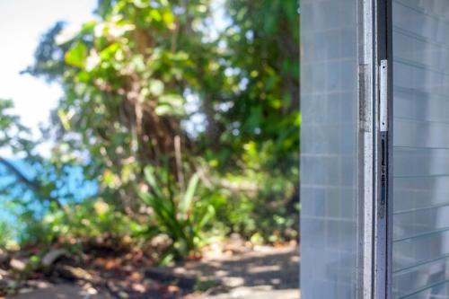 a corner of a building with trees in the background at Frenchman's Cove Resort in Port Antonio
