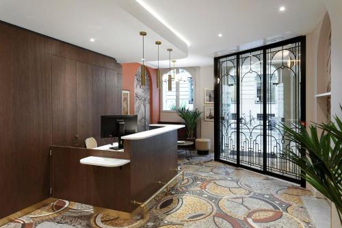 an office with a desk with a computer on it at Timhotel Palais Royal in Paris