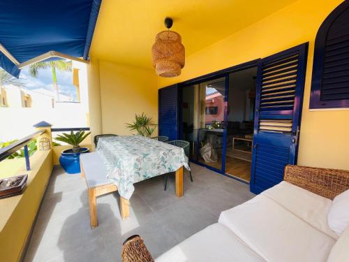 a living room with a table and a couch at Meloneras by the sea in San Bartolomé de Tirajana