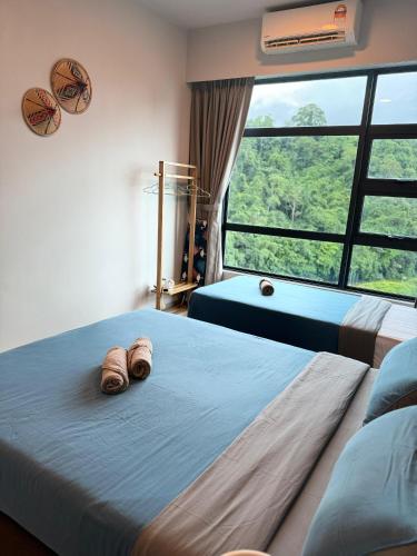 a bedroom with two beds and a large window at JQ#11 City View Slide LoftBed 2R1B 5pax near Suria Mall, Gaya St, SICC in Kota Kinabalu