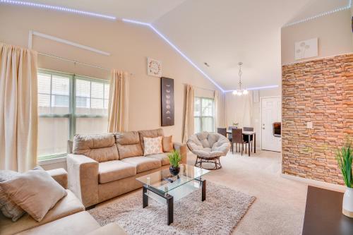 a living room with a couch and a table at 4 Mi to HPU Pet-Friendly Home with Yard! in High Point