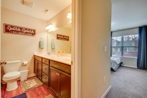 a bathroom with a toilet and a sink and a window at Charming High Point Home with Yard 4 Mi to HPU! in High Point