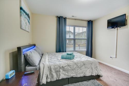 a bedroom with a bed and a couch and a tv at 4 Mi to HPU Pet-Friendly Home with Yard! in High Point