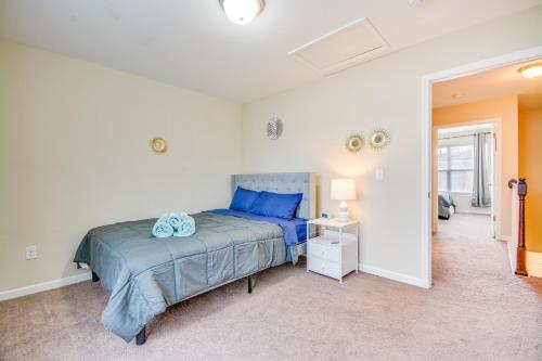 a bedroom with a bed with blue pillows at 4 Mi to HPU Pet-Friendly Home with Yard! in High Point