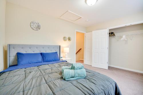 a bedroom with a large bed with blue pillows at 4 Mi to HPU Pet-Friendly Home with Yard! in High Point